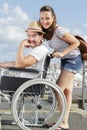 loving couple in wheelchair walking outdoors