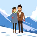 Loving couple in the winter on the background of snowy mountains. Royalty Free Stock Photo