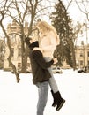 Loving couple in winter. The guy holds in his arms a girl on the street in winter Royalty Free Stock Photo