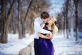 Loving couple in winter, kiss a guy and a girl