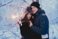 A loving couple on a winter walk. Snow love story, winter magic. Man and woman on the frosty street. The guy and the girl are rest Royalty Free Stock Photo