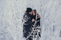 A loving couple on a winter walk. Snow love story, winter magic. Man and woman on the frosty street. The guy and the girl are rest Royalty Free Stock Photo