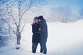 A loving couple on a winter walk. Snow love story, winter magic. Man and woman on the frosty street. The guy and the girl are rest Royalty Free Stock Photo