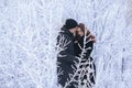 A loving couple on a winter walk. Snow love story, winter magic. Man and woman on the frosty street. The guy and the girl are rest Royalty Free Stock Photo