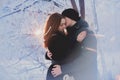 A loving couple on a winter walk. Snow love story, winter magic. Man and woman on the frosty street. The guy and the girl are rest Royalty Free Stock Photo