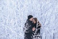 A loving couple on a winter walk. Snow love story, winter magic. Man and woman on the frosty street. The guy and the girl are rest Royalty Free Stock Photo