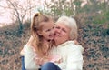 Loving cute granddaughter hugging her grandmother. Happy family.  Having good times with grandparent outdoors Royalty Free Stock Photo