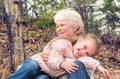 Loving cute granddaughter hugging her grandmother. Happy family.  Having good times with grandparent outdoors Royalty Free Stock Photo