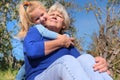 Loving cute granddaughter hugging her grandmother. Happy family.  Having good times with grandparent outdoors Royalty Free Stock Photo