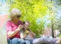 Loving cute granddaughter hugging her grandmother. Happy family.  Having good times with grandparent outdoors Royalty Free Stock Photo