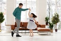 Loving dad dancing with happy cute little daughter at home Royalty Free Stock Photo