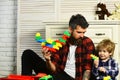 Loving dad and little boy child have fun play build construct with wooden blocks bricks. Father and son create toys from Royalty Free Stock Photo