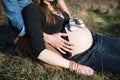 Loving Dad making Heart Shape around Cute Baby Shoes on Pregnant Mother Belly Royalty Free Stock Photo