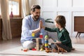 Loving dad play with small son in cozy living room Royalty Free Stock Photo