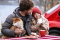 Loving dad on winter holidays has picnic outdoor with little daughter and dog on Christmas vacation Royalty Free Stock Photo