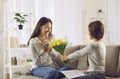 Daughter congratulates her mother on Mother& x27;s Day by giving her flowers and handmade card. Royalty Free Stock Photo