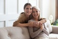 Loving daughter hug mother people posing looking at camera Royalty Free Stock Photo