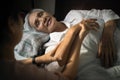 Loving daughter is talking and visiting her sick elderly mother lying in bed,caregiver woman holding hand of asian old patient and Royalty Free Stock Photo