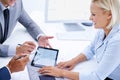 Loving the digital improvements to our industry. a smiling businesswoman meeting with colleagues using a digital tablet. Royalty Free Stock Photo