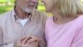 Loving elderly couple looking each other, man and woman holding hands, affection Royalty Free Stock Photo