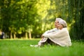 Loving elderly couple sitting on green grass Royalty Free Stock Photo