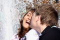 Loving(enamoured) couple kisses against a fountain Royalty Free Stock Photo