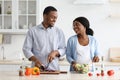 Loving expecting black couple enjoying cooking together Royalty Free Stock Photo