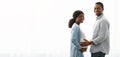 Loving expecting black couple posing over white background