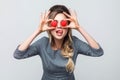 Loving eyes. Beautiful caucasian young woman holding two valentine hearts in front of her eyes like glasses with sensual Royalty Free Stock Photo