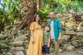 A loving family enjoying a leisurely walk in the park - a radiant pregnant woman after 40, embraced by her husband Royalty Free Stock Photo