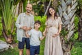 A loving family enjoying a leisurely walk in the park - a radiant pregnant woman after 40, embraced by her husband Royalty Free Stock Photo