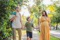 A loving family enjoying a leisurely walk in the park - a radiant pregnant woman after 40, embraced by her husband Royalty Free Stock Photo