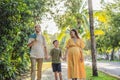 A loving family enjoying a leisurely walk in the park - a radiant pregnant woman after 40, embraced by her husband Royalty Free Stock Photo