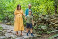 A loving family enjoying a leisurely walk in the park - a radiant pregnant woman after 40, embraced by her husband Royalty Free Stock Photo