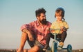 Loving family Father and son. Dad help his child ride a bicycle. Royalty Free Stock Photo