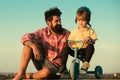 Loving family Father and son. Dad help his child ride a bicycle. Royalty Free Stock Photo