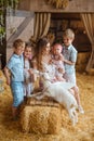 loving family of five, including a caring mother and her four children, are gathered in front of the wooden doors