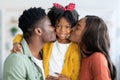 Loving Family. Happy African American Parents Kissing Their Cute Little Daughter Royalty Free Stock Photo