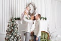 Loving family Merry Christmas and Happy New Year. Cheerful pretty people. Mom and dad hugging little daughter . Parents Royalty Free Stock Photo