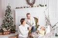 Loving family Merry Christmas and Happy New Year. Cheerful pretty people. Mom, dad and little daughter . Parents and Royalty Free Stock Photo