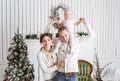 Loving family Merry Christmas and Happy New Year. Cheerful pretty people. Mom, dad and little daughter . Parents and Royalty Free Stock Photo