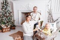 Loving family Merry Christmas and Happy New Year. Cheerful pretty people. Mom, dad and little daughter . Parents and Royalty Free Stock Photo