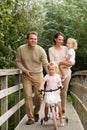 Loving family on small bridge in the park Royalty Free Stock Photo