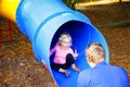 Loving father catching his little daughter at the slide.