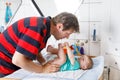 Loving father changing diaper of his newborn baby daughter. Royalty Free Stock Photo