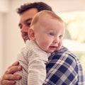 Loving Father Cuddling Baby Son Resting Over Shoulder At Home Together Royalty Free Stock Photo