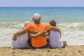 Loving father with his son and daughter in obhimku rest on the seashore or the ocean