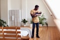 Loving Father Holding Newborn Baby At Home In Loft Apartment