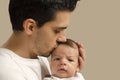 Loving father kissing his new born baby. Royalty Free Stock Photo