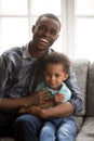Loving father with little son sitting looking at camera indoors Royalty Free Stock Photo